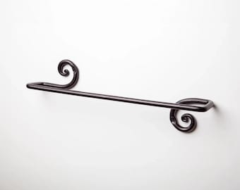 May include: Black metal towel rack with decorative scrollwork on the ends.