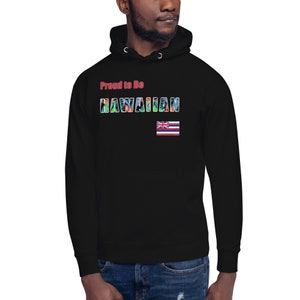 May include: Black hooded sweatshirt with the text "Proud to Be HAWAIIAN". The word HAWAIIAN is filled with a tropical floral pattern. The Hawaiian flag is displayed on the lower right.