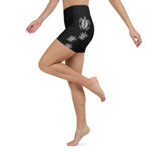 May include: Black athletic shorts with a high waist and a white sea turtle design.