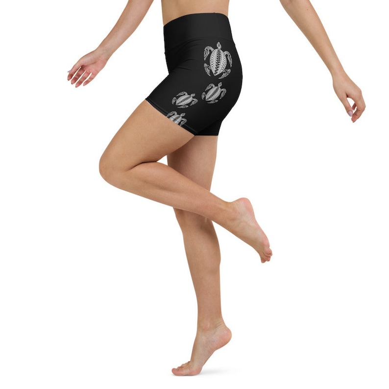 May include: Black athletic shorts with a high waist and a white sea turtle design.