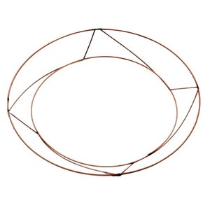 May include: A copper wire wreath form with a smaller inner ring. The rings are connected at four points with black wire.