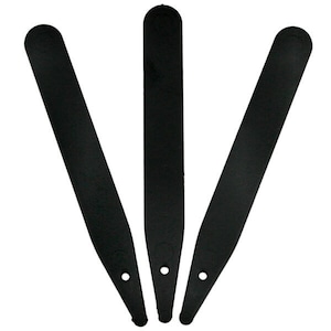 May include: Three black plastic plant labels with rounded ends and a hole in the centre.