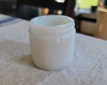 May include: A white ceramic jar with a smooth, rounded surface. The jar has a simple, classic design.