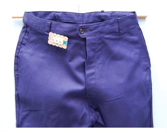 May include: A pair of dark blue work pants with a label that reads "D.A.D."