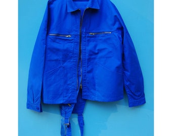 May include: A bright blue work jacket with a zipper closure and multiple pockets. The jacket has suspenders attached.