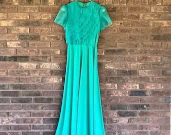 Emerald Green Floor Length Gown• Sheer Fluttery Short Sleeves & Layers• Lined• Zips Up the Back• Excellent Vintage Condition• Well Made