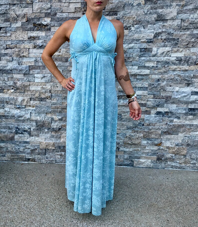 Floor Length Vintage Gown\u2022 Sleeveless\u2022 Pale Blue\u2022 V Neck\u2022 Empire Waist\u2022 Decorative Ties at Sides\u2022 Hidden Zip\u2022 White Flowers\u2022 Form Fitting