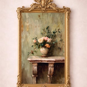 May include: A framed painting featuring a still life of flowers in a vase on a table. The painting has a gold ornate frame. The flowers are pink and orange, and the background is a muted green.