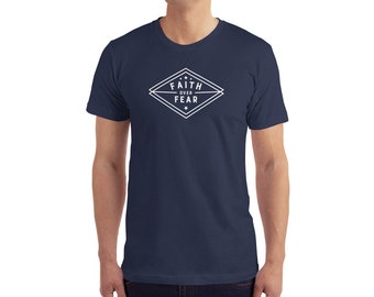 May include: A navy blue t-shirt with a white diamond-shaped graphic that says "Faith Over Fear" in a white sans-serif font.