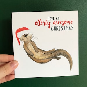 Une carte illustrée de NOL TRES IMPRESSIONNANTE par Catherine Redgate humour amusant lunatique décalé mignon Noël loutre drôle loutres jeu de mots