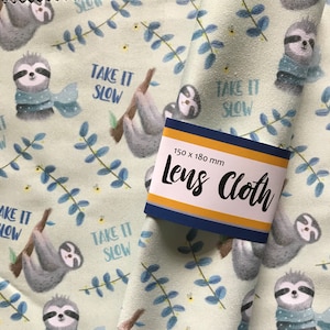 May include: A green lens cloth with a sloth pattern. The cloth has the text "Take it slow" repeated throughout. The cloth is 150 x 180 mm.