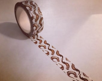 May include: A roll of washi tape with a brown otter pattern on a white background.