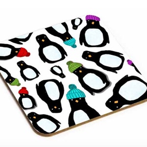 May include: A white coaster with a repeating pattern of black penguins wearing colourful hats. The hats are red, green, blue, and purple.