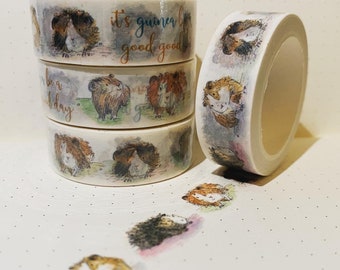 May include: Four rolls of washi tape featuring a guinea pig theme. The tape has illustrations of guinea pigs with the text "it's guinea pig good good" and "be a good day".