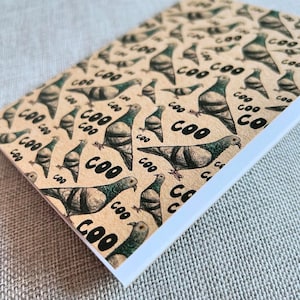 May include: A brown card with a repeating pattern of black and white pigeons with the word "COO" printed in black on a beige background.