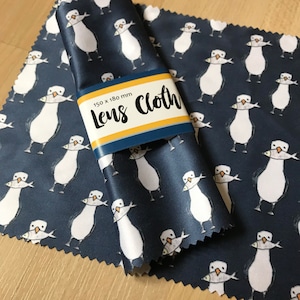 May include: A blue microfiber lens cleaning cloth with a white seagull pattern and the text "150 x 180 mm Lens Cloth".