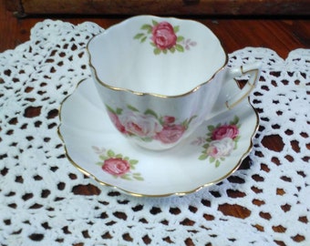 Victoria tea cup and saucer. white and red roses with gold trim.