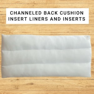 May include: A rectangular white cushion insert featuring horizontal channeled stitching. The text CHANNELED BACK CUSHION INSERT LINERS AND INSERTS is displayed in black capital letters above the white cushion on a light wood grain background.