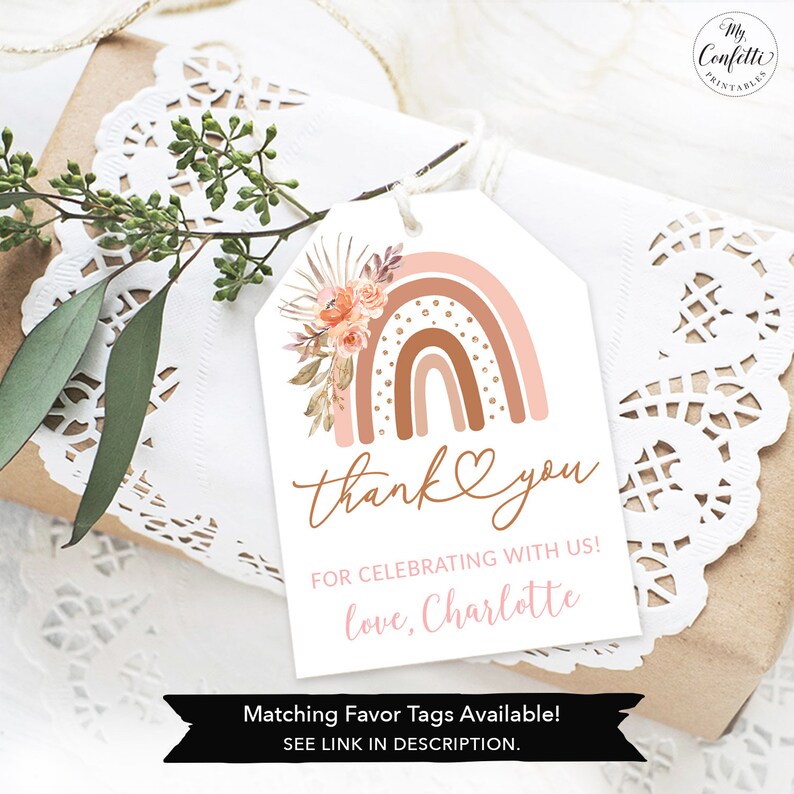 May include: A pink and brown rainbow with gold accents and floral details. The tag says "thank you" and "for celebrating with us! love, Charlotte". Matching favor tags are available.