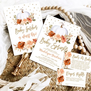 May include: A set of printable baby shower invitations with a fall theme. The invitations feature a white pumpkin with orange and peach flowers, gold glitter, and the text "Baby Gardner is almost here!" and "Baby Sprinkle, Please join us for a baby sprinkle in honor of Madelyne Gardner". The invitations also include a "Books for Baby" card and a "Diaper Raffle" card.