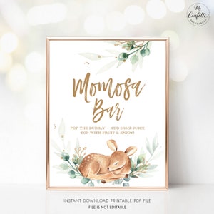 May include: A framed sign with a gold border displays the words "Momosa Bar" in gold script. The sign includes the text "Pop the bubbly, add some juice, top with fruit & enjoy!" A watercolor illustration of a sleeping fawn and greenery decorates the bottom.