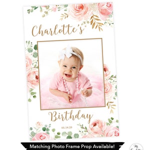 May include: A photo frame with the text "Charlotte's Birthday" and a photo of a baby girl. The frame is decorated with pink roses and green leaves. The date "05.18.23" is below the word "Birthday". The bottom of the frame has the text "Matching Photo Frame Prop Available! SEE LINK IN DESCRIPTION".