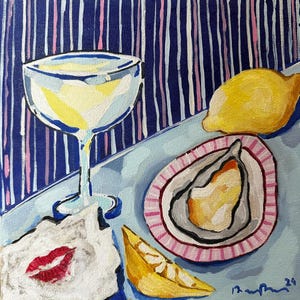 May include: An original painting depicts a still life with a cocktail glass, oyster, lemon, and a napkin with red lips. The background features blue and white vertical stripes. The artwork is a vibrant display of food and drink.