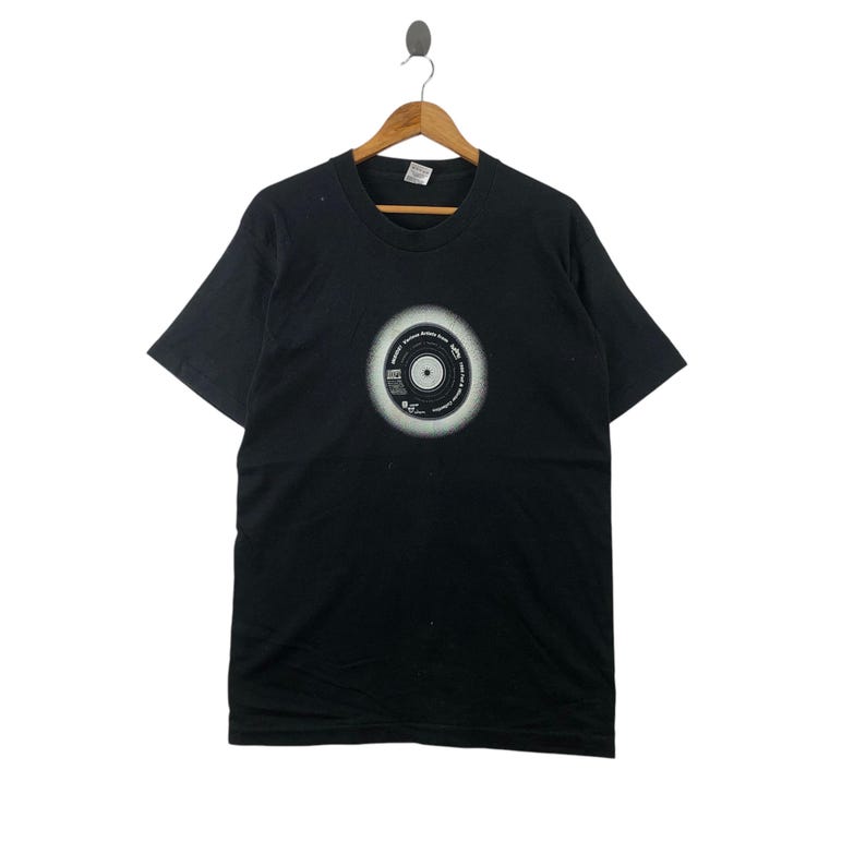 May include: Black t-shirt with a white graphic of a vinyl record with the text "Original Album Series" and "The Beatles" printed on it.