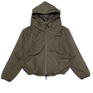 May include: An olive green hooded jacket featuring a full-length front zipper, long sleeves with elastic cuffs, and a drawstring hood. The garment includes two large, gathered front pockets with drawstring closures and a dark interior lining.