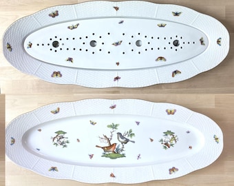 May include: An oval white porcelain serving platter with a scalloped edge and a basket-weave texture. The platter features colorful butterfly motifs and a central illustration of two birds perched on branches, with a matching perforated insert.