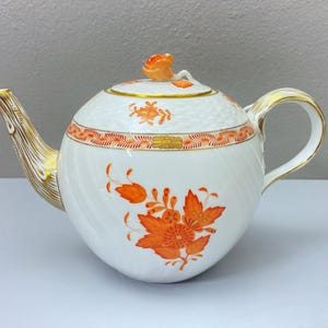 Herend "Chinese Bouquet " Apponyi Orange teapot  (1063/AOG), rose finial, accents of 24k gold. Tiny chip to the rose petal, holds 35OZ