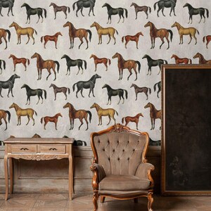 May include: Wallpaper featuring a repeating pattern of horses in various shades of brown, black, and tan against a light gray background. A wooden console table with two drawers and a tufted brown armchair are positioned in front of the wall.