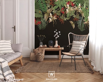 May include: A black and white striped throw blanket draped over a wooden couch with a black and white striped pillow. A black and white striped pillow is on a wicker chair with black metal legs. A brown woven rug is on the floor. A black wall with a green and red floral mural is in the background. The text "WALLCOLORS" is on the rug.