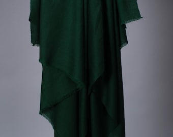 May include: A deep green fabric with a fringed edge. The fabric is draped over a black rod.