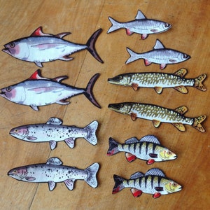 May include: A collection of eight hand-painted fish illustrations, including tuna, trout, pike, and perch. The fish are painted in realistic detail with various colors and patterns.