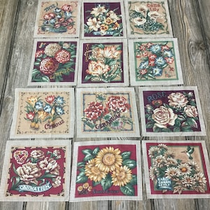 May include: Twelve fabric squares with floral designs and names of flowers, including Iris, Lily, Rose, Carnation, Sunflower, and Geranium. The squares are beige with a checkered pattern border.
