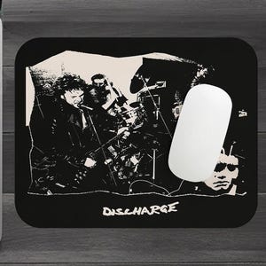 May include: Black and white illustration of a punk rock band, Discharge, on a black mouse pad. The band members are playing instruments and the band's name is printed in white letters.