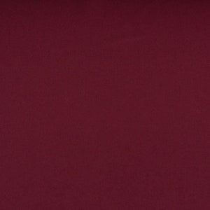 Könnte beinhalten: Ein einfarbiger, tief burgunderfarbener Stoff mit einer glatten, gleichmäßigen Textur.