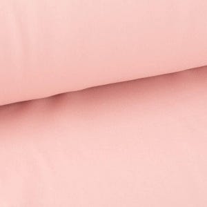 Könnte beinhalten: Nahaufnahme eines weichen, hellrosa Stoffes. Der Stoff hat eine glatte, gleichmäßige Textur.
