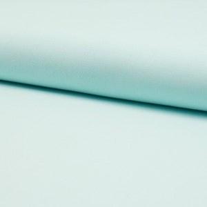 Könnte beinhalten: Ein glatter, hellblauer Stoff mit einer dezenten Textur. Der Stoff ist in der Mitte gefaltet und zeigt die Unterseite.