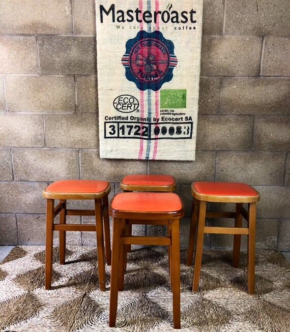 A Retro Set of Four Sunshine Orange Stools with Solid Beechwood Frames