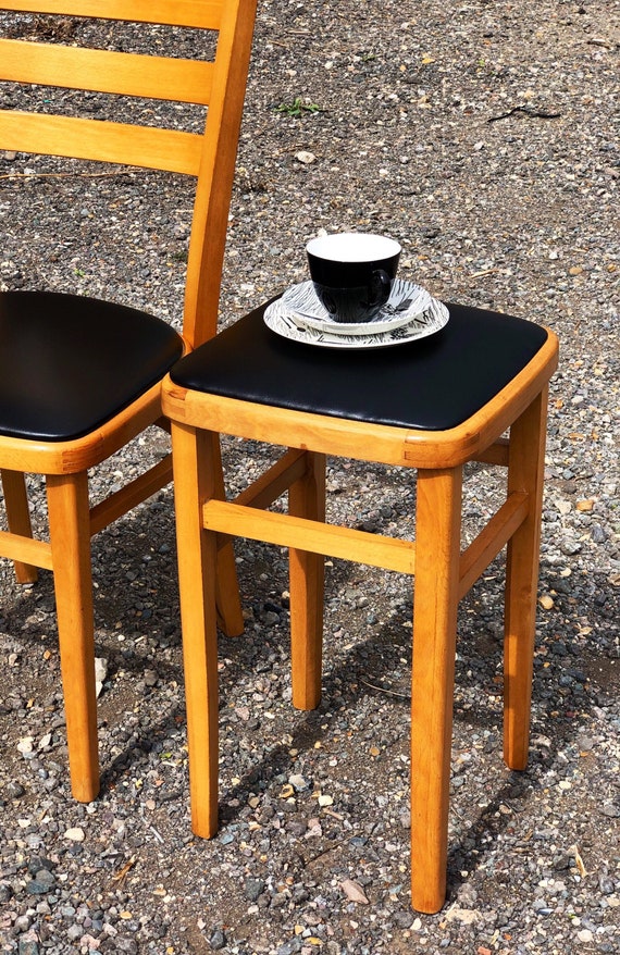 A Reupholstered Retro Black Vinyl Stool