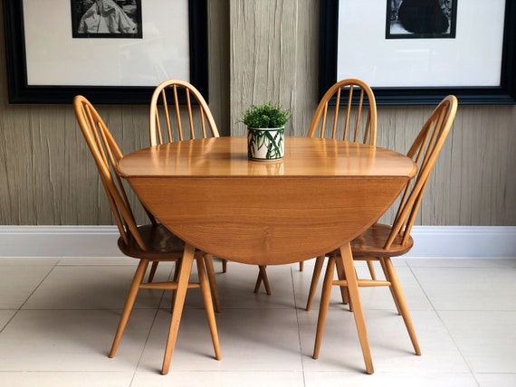 An Ercol Round Drop Leaf Table with A Set of 4 Ercol 365 Blond Chairs