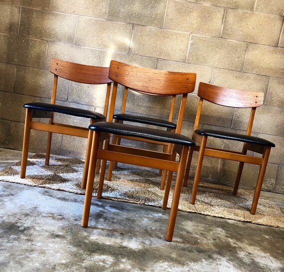 A Set of Vintage Danish Dining Chairs Teak with Black Vinyl Seats