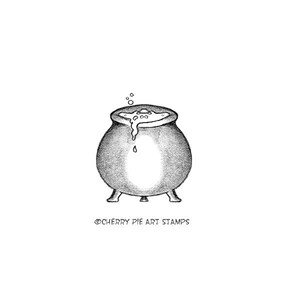 May include: A black and white illustration of a cauldron with bubbling liquid and steam rising from the top. The cauldron is on three legs and has a rounded bottom. The image is from Cherry Pie Art Stamps.