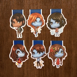 May include: A set of three ceramic nesting bowls in shades of blue, green, and white. The bowls feature a speckled glaze and a simple, modern design. The largest bowl measures approximately 6 inches in diameter.