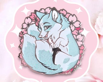 May include: A light blue enamel pin of a fox curled up with its tail around its body. The fox has a pink nose and a white chest. The fox is surrounded by pink cherry blossoms.