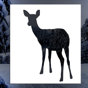 May include: A black silhouette of a deer standing in a snowy forest. The deer is facing to the right and has its head turned to the left. The deer is standing in front of a snowy forest with tall trees.