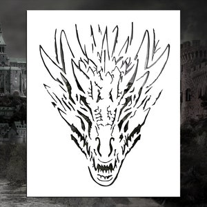 May include: A black and white stencil of a dragon's head with sharp teeth and a fierce expression.