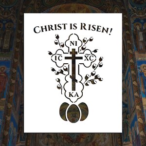 May include: A white stencil with the text "CHRIST IS RISEN!" and a black silhouette of a cross with the letters "IC XC NI KA" and a wreath of branches with buds around the cross. The cross is sitting on top of three overlapping black eggs.